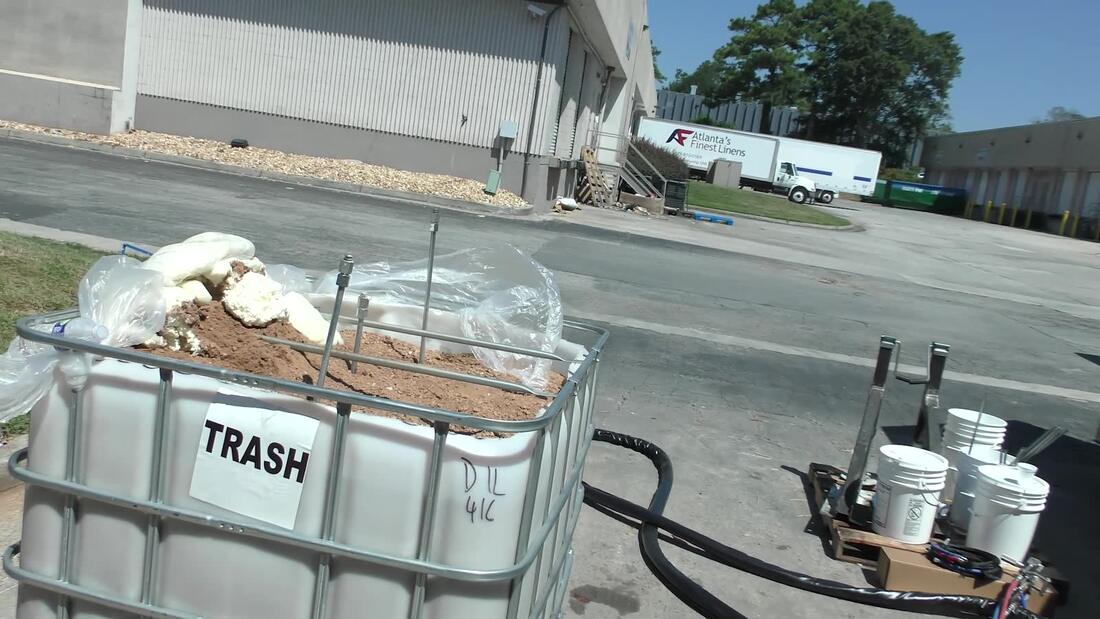 IBC waste tote labeled TRASH